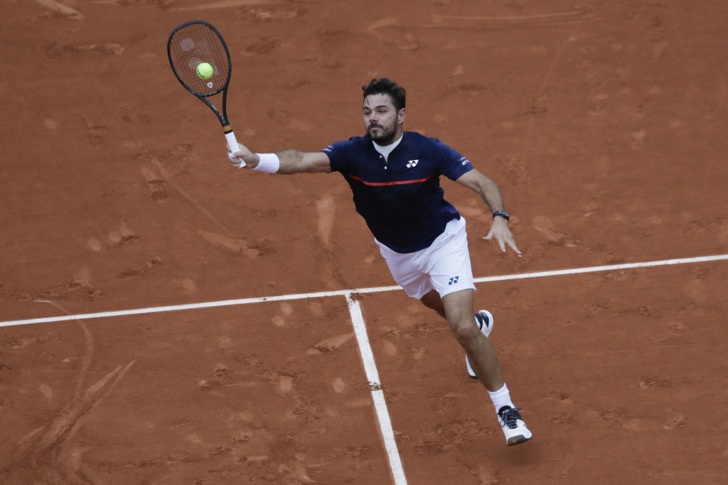 Switzerland's Stan Wawrinka plays a shot against France's Hugo Gaston in the third round match of the French Open tennis tournament at the Roland Garros stadium in Paris, France, Friday, Oct. 2, 2020. (AP Photo/Alessandra Tarantino)