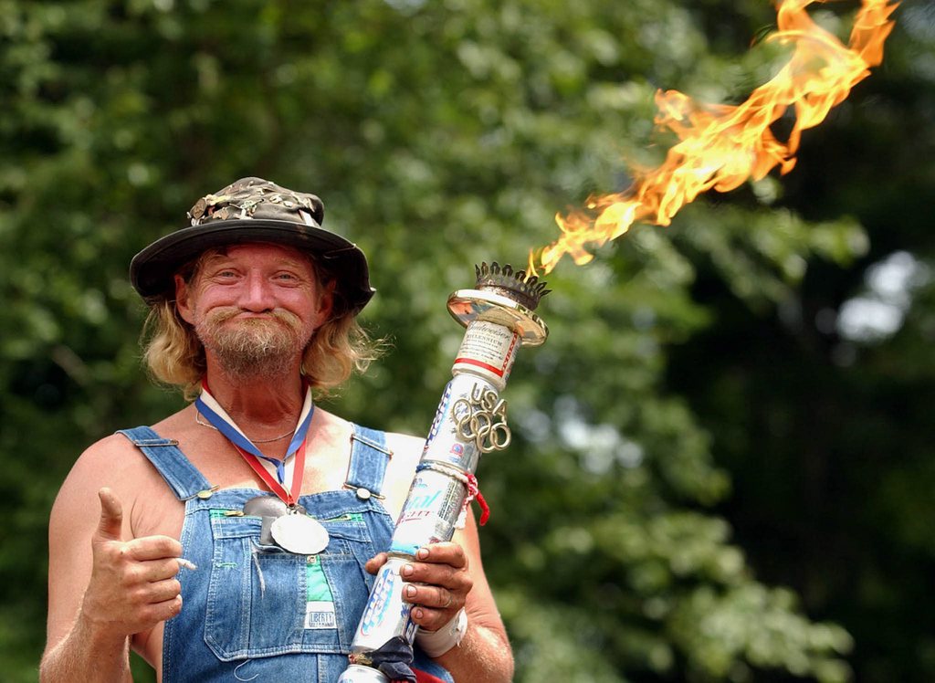 Mascot Randy "L-Bow" Tidwell lights his ceremonial propane torch to mark the start of the 8th annual Summer Redneck Games, 05 July 2003, in East Dublin, Ga. The annual event in the south Georgia town, features a variety of events poking fun at the prevailing redneck culture of the area.  EPA PHOTO/EPA/ERIK S. LESSER