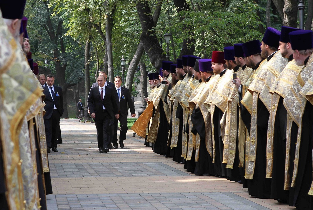 Russian President Vladimir Putin, center, arrives for a religious service marking the1025th anniversary of Christianity in Ukraine and Russia, in Kiev, Ukraine, Saturday, July 27, 2013. Putin is in Kiev to attend celebrations marking the1025th anniversary of Christianity in Ukraine and Russia. (AP Photo/RIA-Novosti, Mikhail Klimentyev, Presidential Press Service)