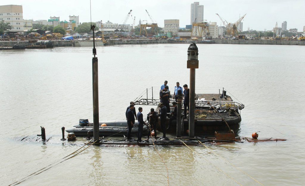 epa03824725 A handout photograph provided by the Indian Ministry of Defence on 14 August 2013 shows rescue work continuing at the site of an explosion on an Indian Navy submarine in Mumbai, India, 14 August 2013. An explosion and a major fire on board an Indian Navy submarine docked in Mumbai early 14 August may have left about 18 people trapped, officials said. The fire occurred on the newly-upgraded INS Sindhurakshak at the naval dockyards shortly after midnight and firefighters had managed to bring the blaze under the control, navy spokesman PV Satish said. The explosion was reportedly caused by an electrical short-circuit or a battery problem. Defence Minister AK Antony confirmed that sailors had died in an explosion and fire on board a submarine in naval dockyards.  EPA/INDIAN MINISTRY OF DEFENCE / HANDOUT  HANDOUT EDITORIAL USE ONLY/NO SALES/NO ARCHIVES
