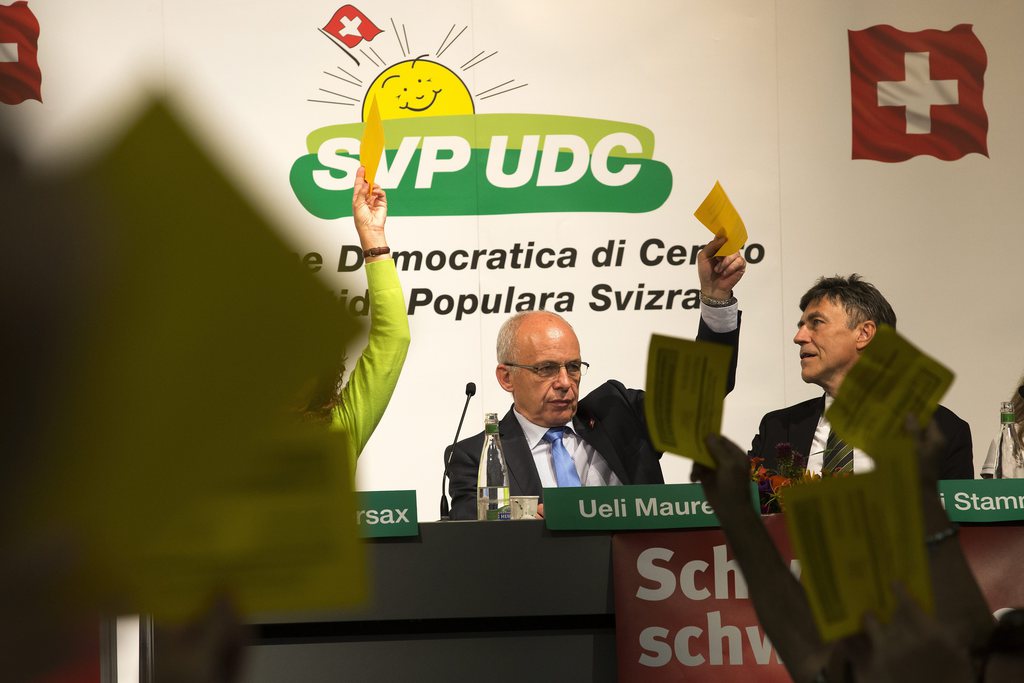 Ueli Maurer, president de la Confederation Suisse, vote avec les delegues de l' UDC pour leur mot d'ordre sur l'initiative du Groupe pour une Suisse sans armee (GSsA) visant a abroger l'obligation de servir, lors de l'assemblee des delegues du parti de l' Union Democratique du Centre, UDC, ce samedi 24 August 2013 a Geneve. (KEYSTONE/Salvatore Di Nolfi)