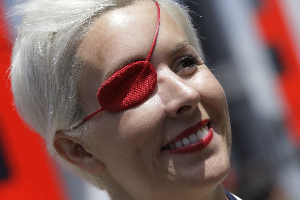 FILE - Spanish former F1 driver Maria De Villota smiles in the paddock prior to the start of qualifying session at the Catalunya racetrack in Montmelo, near Barcelona, Spain, in this May 11, 2013 file photo. Spanish police have confirmed Friday Oct. 11, 2013 that racing driver Maria de Villota has been found dead in a hotel room in Seville, and say it appears she died of natural causes. She was 33. De Villota was seriously injured last year in a crash during testing for the Marussia Formula One team, losing her right eye and sustaining other serious head injuries. (AP Photo/Luca Bruno)