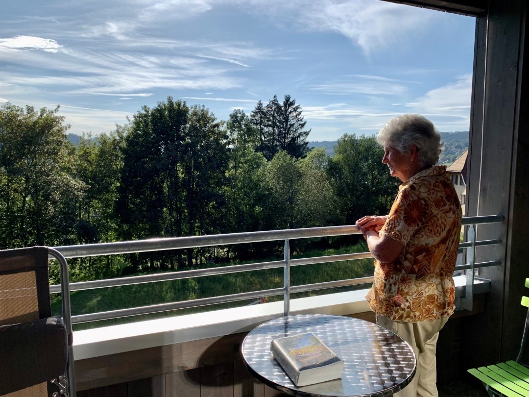 Depuis sa terrasse, Anne-Marie profite de la vue sur la nature. Un élément qui compte pour elle, qui a toujours vécu à la campagne.