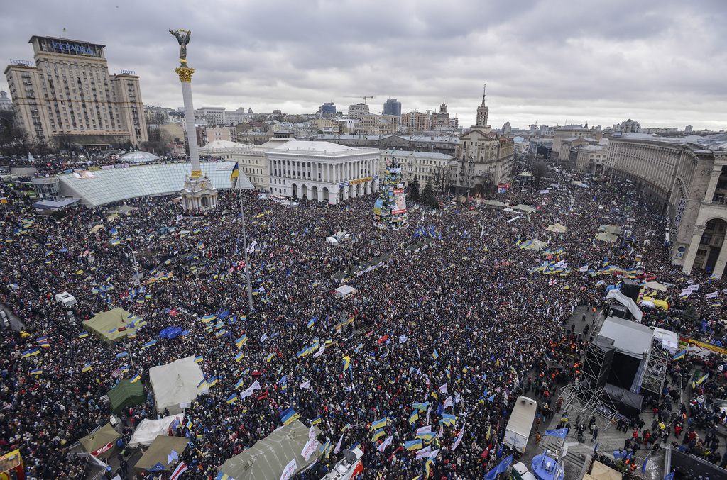 Pro-European Union activists gather during a rally in Independence Square and Kreshchatik, the main street of Kiev, Ukraine, Sunday, Dec. 8, 2013. The third week of protests continue Sunday with an estimated 200,000 Ukrainians occupying central Kiev to denounce President Viktor Yanukovych?s decision to turn away from Europe and align this ex-Soviet republic with Russia. (AP Photo/Andrew Kravchenko)