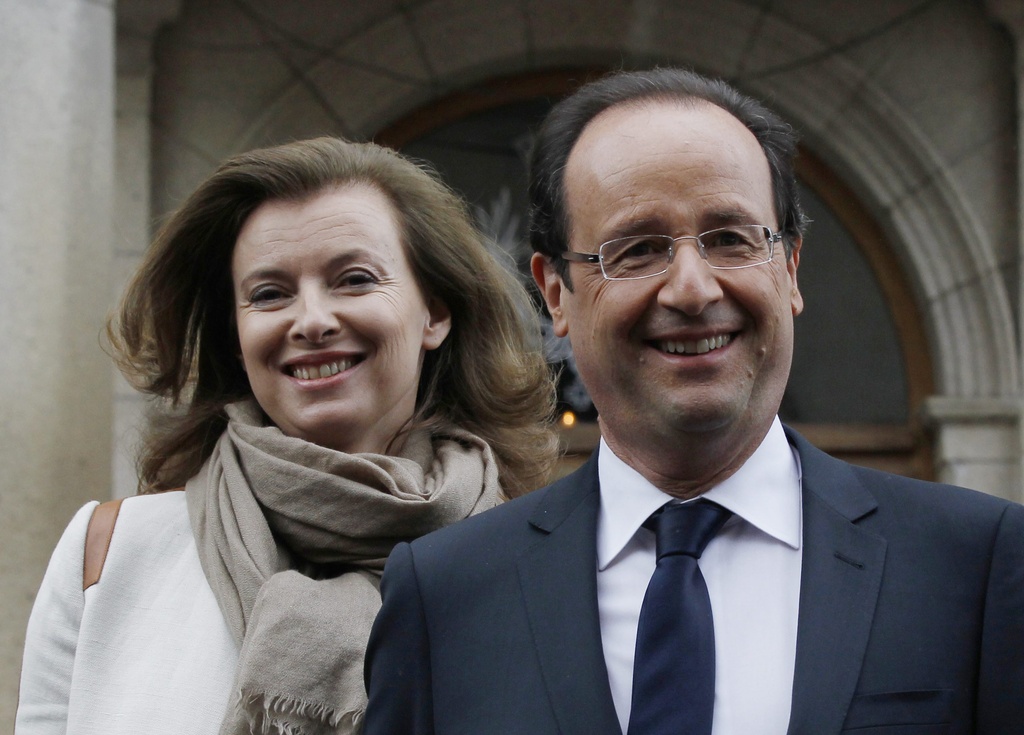 Socialist Party candidate for the presidential election Francois Hollande exits a polling station with his companion Valerie Trierweiler as he tours after voting in the second round of the presidential election in Tulle, central France, Sunday, May 6, 2012.  (AP Photo/Christophe Ena)