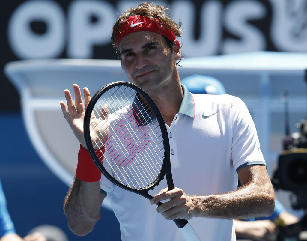 Roger Federer of Switzerland celebrates his win over James Duckworth of Australia after their first round match at the Australian Open tennis championship in Melbourne, Australia, Tuesday, Jan. 14, 2014.(AP Photo/Eugene Hoshiko)