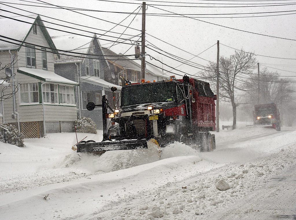 Snowplows clear streets in Dartmouth, Nova Scotia on Wednesday, March 26, 2014. An early spring storm has disrupted travel and closed schools and businesses across the region. (AP Photo/The Canadian Press, Andrew Vaughan)
