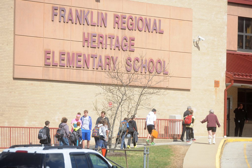 epa04160700 Parents and children are reunited at an organized pick up for parents at the Elementary School following a stabbing spree at Franklin Regional Senior High School by a reported 16-year-old student which injured twenty students and staff at the school in Murrysville, Pennsylvania, USA, 09 April 2014. At least four people were facing life-threatening wounds on 09 April after a knife-wielding student allegedly stabbed at least 20 fellow students and a 60-year-old security guard at a high school in the US state of Pennsylvania. In the half hour before classes started, the 16-year-old suspect allegedly went down the hallway with a knife in each hand, slashing students across their torsos, according to Murrysville Police chief Thomas Seefeld at a broadcast press conference.  EPA/VINCENT PUGLIESE
