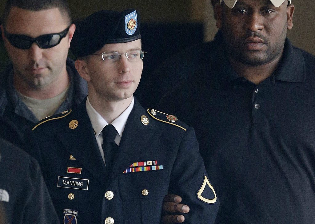 FILE - In this Tuesday, Aug. 20, 2013 file photo, Army Pfc. Bradley Manning is escorted to a security vehicle outside a courthouse in Fort Meade, Md., after a hearing in his court martial. Manning plans to live as a woman named Chelsea and wants to begin hormone therapy as soon as possible, the soldier said Thursday, Aug. 22, 2013, a day after he was sentenced to 35 years in prison for sending classified material to WikiLeaks. (AP Photo/Patrick Semansky, File)