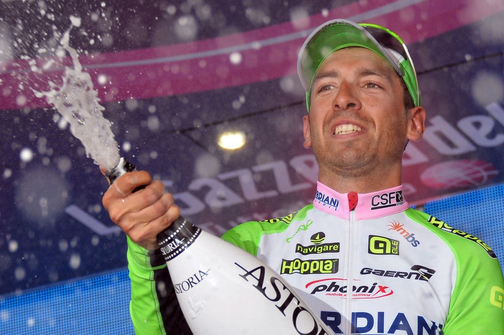 Italy's Stefano Pirazzi receives the kisses of the race's hostesses after winning the 17th stage of the Giro d' Italia cycling race from Sarnonico to Vittorio Veneto, Italy, Wednesday, May 28, 2014. Stefano Pirazzi won the 17th stage of the Giro d'Italia on Wednesday, while Nairo Quintana retained the overall leader's pink jersey. Pirazzi, who had led from the breakaway, made his move with little more than a kilometer remaining and edged out Tim Wellens and Jay McCarthy in a sprint at the end of the 204-kilometer (127-mile) stage from Sarnonico to Vittorio Veneto. (AP Photo/Gian Mattia D'Alberto)