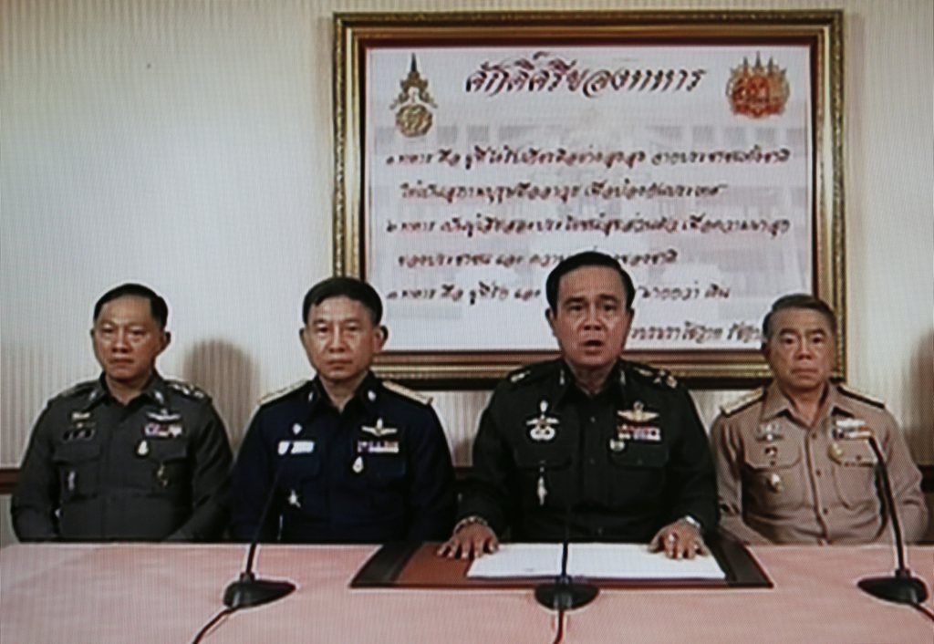 A TV grab shows Army Chief General Prayuth Chan-ocha (2-R) speaking next to Navy Chief Adm Narong Pipattanasai (L), Air Chief Marshall Prachin Chantong (2-L) and Thai Police Chief Adul Saengsingkaew (R) during a military coup televised nationwide at the Army Club in Bangkok, Thailand, 22 May 2014. Thai Army chief Prayuth Chan-ocha announced a coup after his efforts to reconcile rival political factions failed.  EPA/RUNGROJ YONGRIT