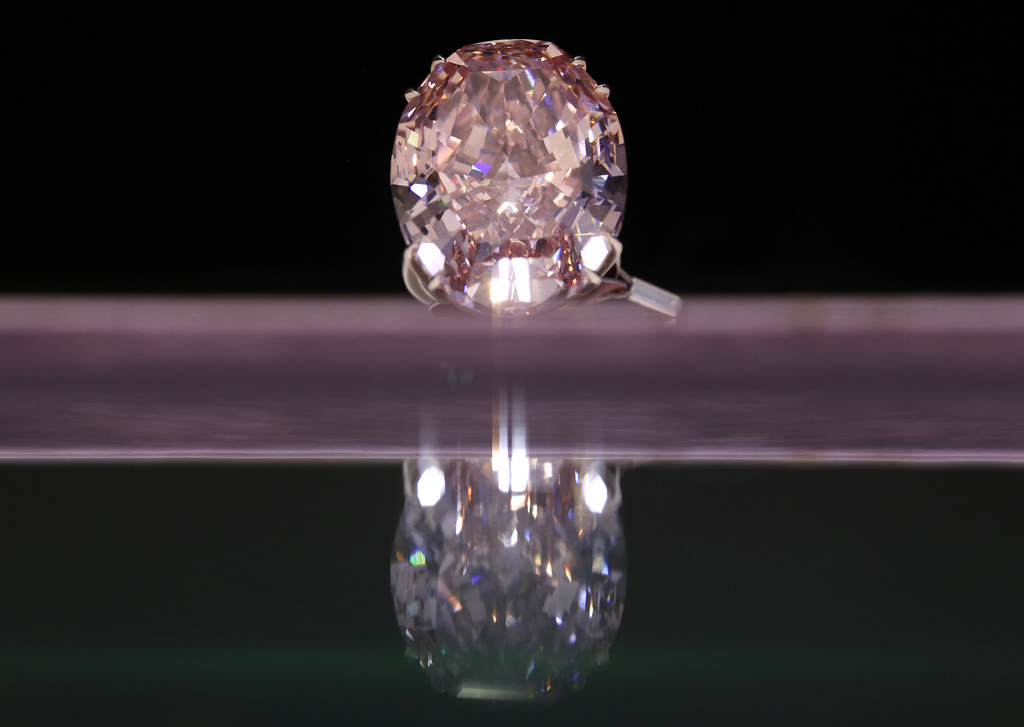 The Pink Star Diamond weighing 59.6 carat is displayed during a press preview at Sotheby's in Hong Kong Thursday, Oct. 3, 2013. The Pink Star Diamond, one of the world's natural treasures, is the most valuable diamond ever to be offered at auction, estimated in excess of US$ 60 million. The internally flawless fancy vivid pink diamond will be auctioned in Geneva on Nov. 13. (AP Photo/Vincent Yu)