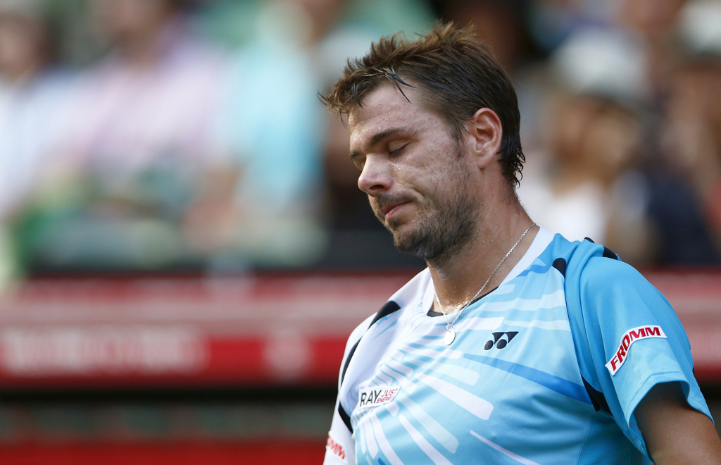 Stanislas Wawrinka of Switzerland reacts after losing a point against Tatsuma Ito of Japan during their first round match of Japan Open Tennis Championships in Tokyo, Tuesday, Sept. 30, 2014. (AP Photo/Shizuo Kambayashi)