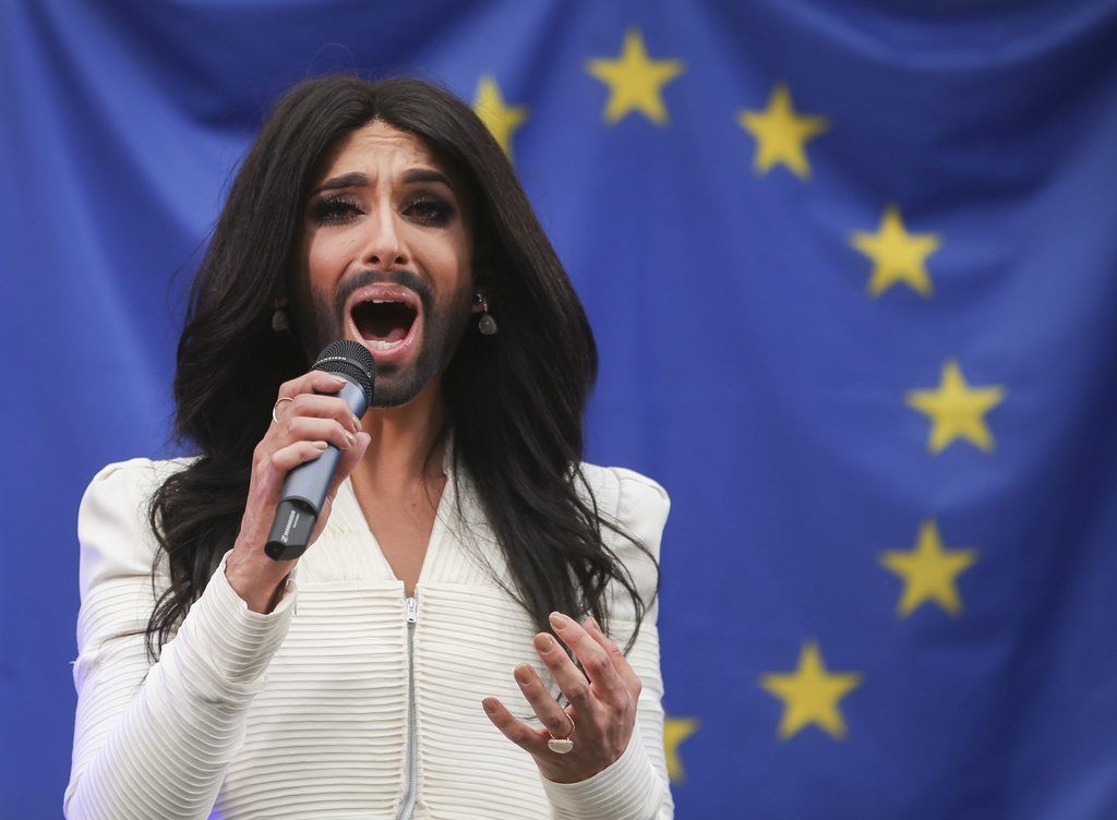 epa04436879 Eurovision Song Contest winner Conchita Wurst of Austria sings during a show in front of  European Parliament in Brussels, Belgium, 08 October 2014. Conchita Wurst will perform outside the European Parliament, in a concert organised by members of Parliament aiming to support the adoption in February 2014 of the report against homophobia and sexual discriminations.  EPA/OLIVIER HOSLET