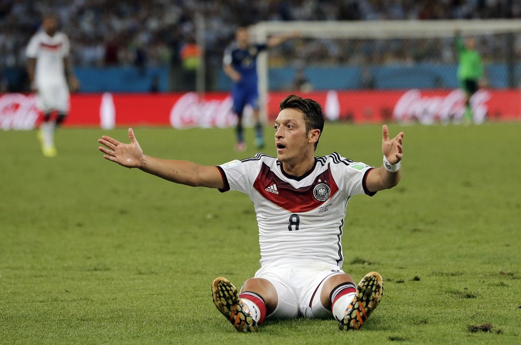 Germany's Mesut Ozil gestures for an official's call after a fall during the World Cup final soccer match between Germany and Argentina at the Maracana Stadium in Rio de Janeiro, Brazil, Sunday, July 13, 2014. (AP Photo/Matthias Schrader)