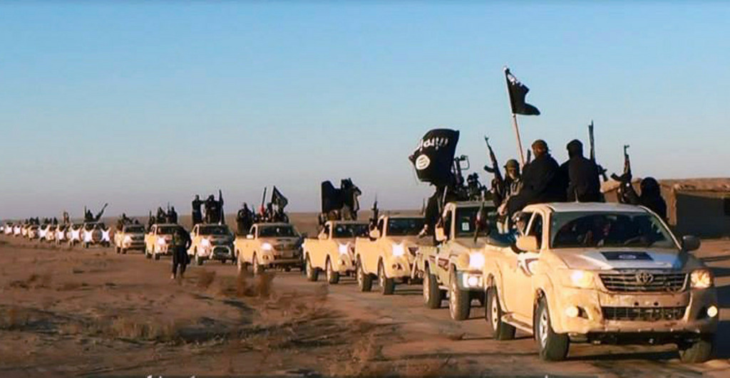 FILE - This file image posted on a militant website on Tuesday, Jan. 7, 2014, which is consistent with AP reporting, shows a convoy of vehicles and fighters from the al-Qaida-linked Islamic State of Iraq and the Levant, now called the Islamic State group, in Iraq's Anbar Province. ?We can?t stop this thing, but we can limit it,? a former Islamic State group commander told the Associated Press of the Sunni militant group?s ambition to create a self-styled caliphate. ?Daesh has nothing to lose,? he added, using the group?s Arabic acronym. ?They like it when (they are) hot in the news.? The former commander was interviewed at an Iraqi prison where he is now held and works as an informant.(AP Photo/militant website, File)