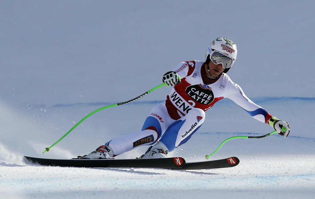 Carlo Janka crosses the finish line to complete an alpine ski, men's World Cup downhill, in Wengen, Switzerland, Sunday, Jan. 18, 2015. (AP Photo/Giovanni Auletta)