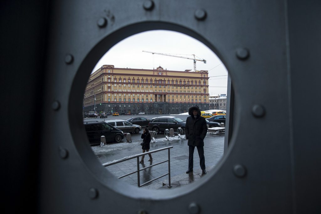 A security man stands in Lubyanka Square, with the main building of the Russian Federal Security Service, former KGB headquarters, in the background, in Moscow, Russia, Tuesday, Jan. 27, 2015. A long-awaited inquiry into the death of former Russian spy Alexander Litvinenko opened Tuesday in London  with the revelation that the KGB agent turned Kremlin critic may have been poisoned with radioactive polonium not once, as authorities initially thought, but twice. (AP Photo/Pavel Golovkin)