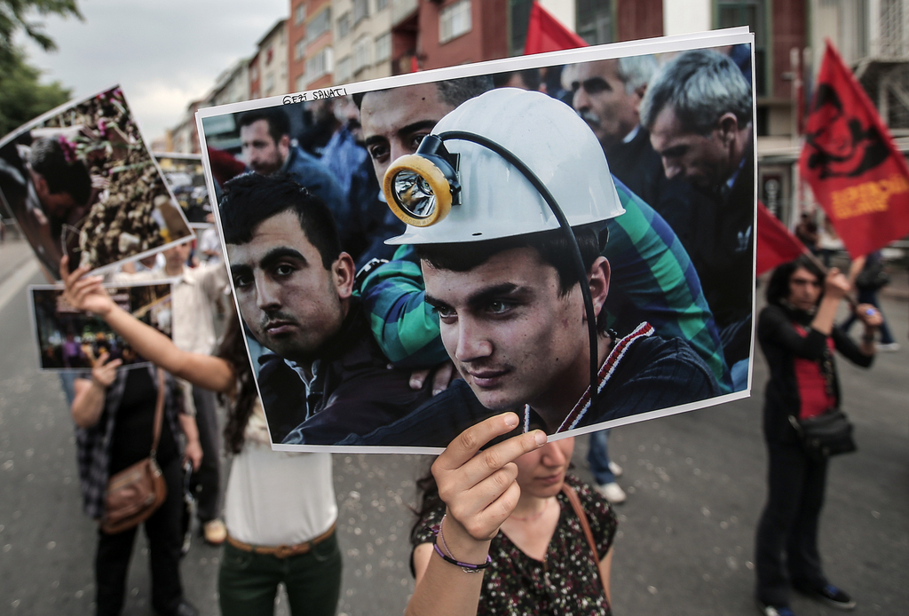 Thousands of people, some carrying images of miners, march to protest the Soma mine disaster that killed 301 miners last week, in Istanbul, Turkey, Sunday, May 25, 2014.(AP Photo/Emrah Gurel)