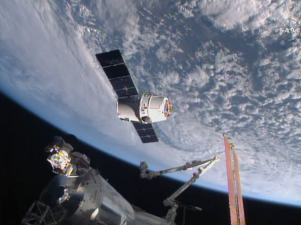 In this image from NASA-TV shows the SpaceX Dragon-6 resupply capsule Friday April 17, 2015 as it holds at the grapple point, 10 meters from the International Space Station as they cross over the Asia. (NASA-TV via AP)