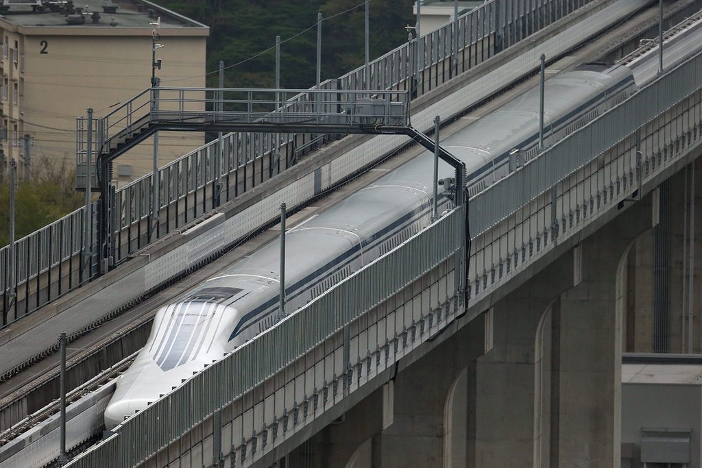 epa04714048 A handout picture provided by the Central Japan Railway Co shows a maglev train speeding on an experimental track in Yamanashi Prefecture, central Japan, 21 April 2015. Central Japan Railway Co said its Magnetic Levitation train set a world speed record of 603 kilometers per hour during a manned test run in central Japan. The company began construction work in December 2014 for the maglev train service connecting Shinagawa in Tokyo and Nagoya, central Japan, which is scheduled to be launched in 2027.  EPA/JR CENTRAL  HANDOUT EDITORIAL USE ONLY/NO SALES