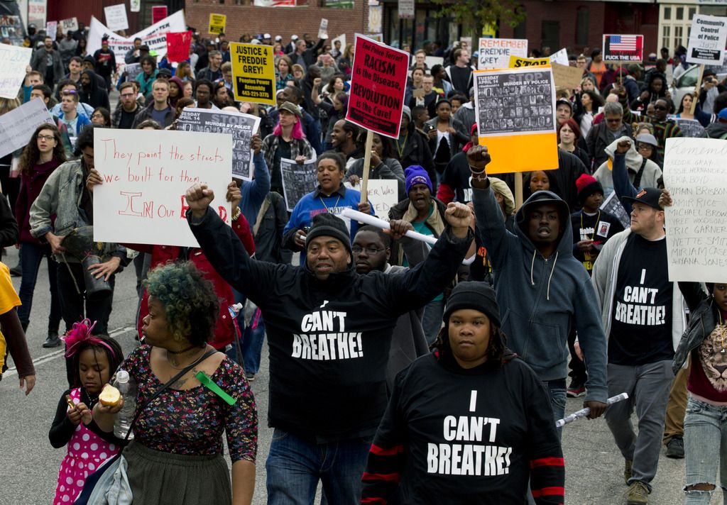 Demonstrators protest in the streets as they march for Freddie Gray to Baltimore's City Hall, Saturday, April 25, 2015. Gray died from spinal injuries about a week after he was arrested and transported in a police van. (AP Photo/Jose Luis Magana)