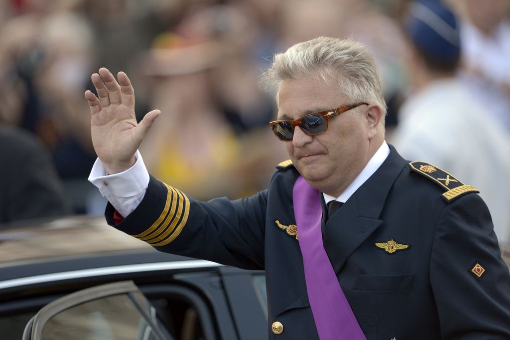 Belgium's Prince Laurent waves as he leaves a church service at the St. Gudule cathedral in Brussels on Sunday, July 21, 2013. Belgium's King Albert II was set Sunday to relinquish the throne in a concession to his age and health, paving the way for his eldest son to become the country's seventh monarch. (AP Photo/Ezequiel Scagnetti)