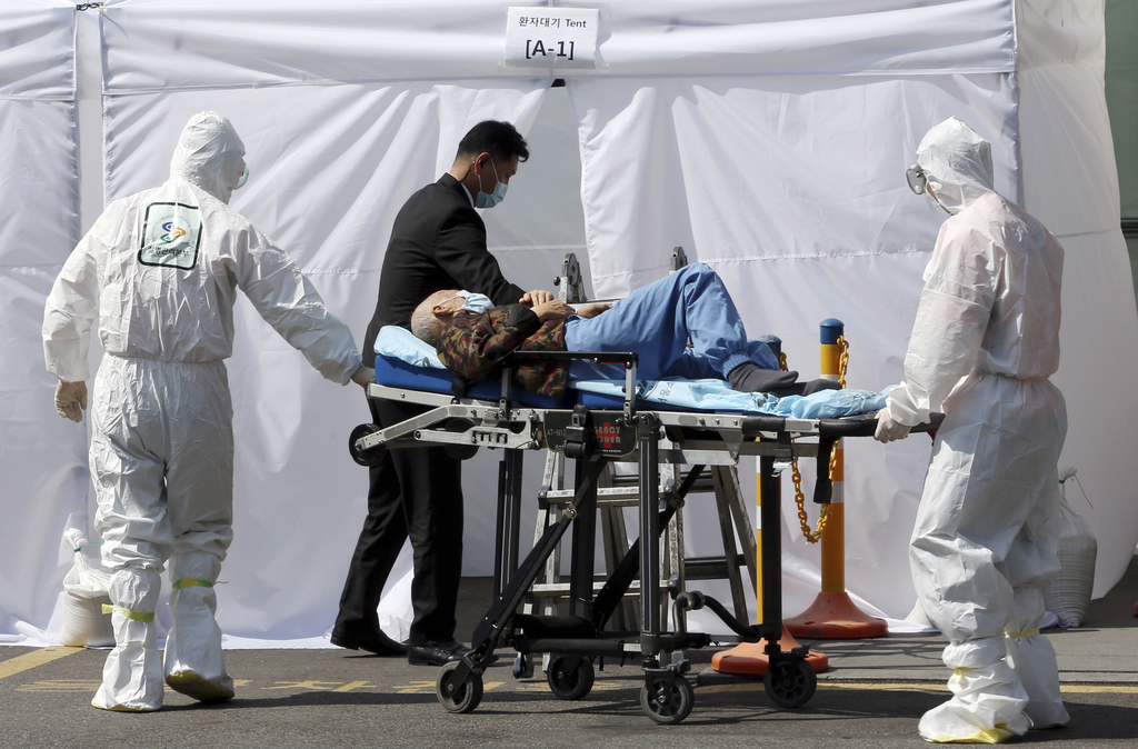 Hospital workers wearing protective gears as a precaution against the Middle East Respiratory Syndrome virus push a wheeled stretcher carrying a suspected MERS patient at Samsung Medical Center in Seoul, South Korea Wednesday, June 10, 2015. South Korea believes its MERS virus outbreak may have peaked, and experts say the next several days will be critical to determining whether the government's belated efforts have successfully stymied a disease that has killed seven people and infected nearly 100 in the country. (Hong Hae-in/Yonhap via AP) KOREA OUT