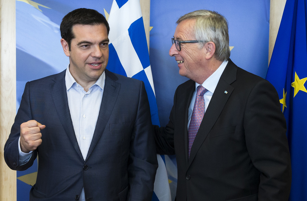 Greek Prime Minister Alexis Tsipras, left, is greeted by European Commission President Jean-Claude Juncker prior to a meeting at EU headquarters in Brussels on Wednesday, June 24, 2015. Eurozone finance ministers meet Wednesday to discuss the Greek bailout. (Julien Warnand/Pool Photo via AP)