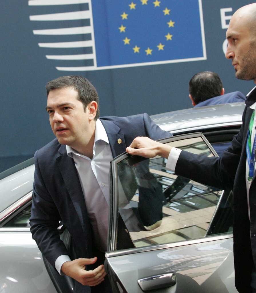 Greek Prime Minister Alexis Tsipras, center, arrives for an EU summit in Brussels on Friday, June 26, 2015. Greece and its creditors launched a new round of talks in Brussels early Thursday in a fresh bid to unlock billions of euros in loans and save the country from bankruptcy. (AP Photo/Francois Walschaerts)