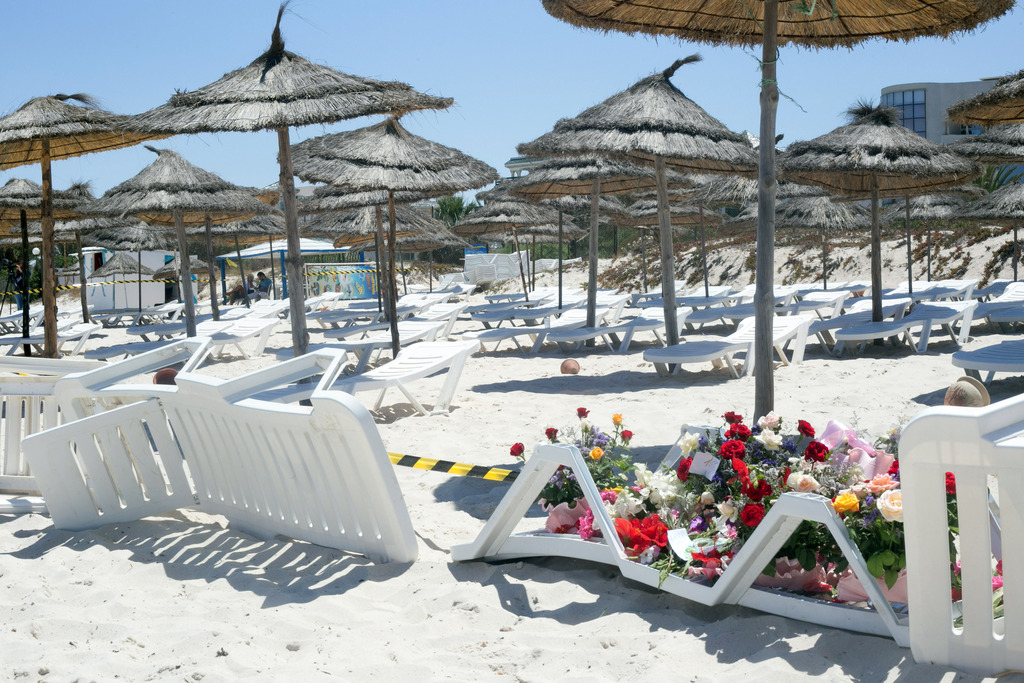 Flowers are laid at the scene of Friday's shooting attack in the coastal town of Sousse, Tunisia, Saturday, June 27, 2015. Tunisia's prime minister announced on Saturday a string of new security measures including closing renegade mosques and calling up army reservists as thousands of tourists fled the North African country in wake of its worst terrorist attack ever. Tourists crowded into the airport at Hammamet near the coastal city of Sousse where a young man dressed in shorts on Friday pulled an assault rifle and grenades out of his beach umbrella and killed 38 people, mostly tourists. (AP Photo/Leila Khemissi)