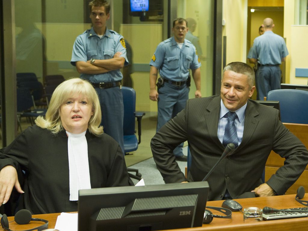 Naser Oric, right, and his lawyer Vasvija Vidovic, left, sit in the courtroom of the Yugoslav war crimes tribunal in The Hague, Netherlands, Thursday July 3, 2008. A U.N. appeals court has overturned the war crimes conviction of Oric, a Bosnian Muslim considered a war hero by many in his country for fighting Serbs in the embattled U.N. safe haven of Srebrenica during the1992-95 war. Oric, 41, was convicted two years ago of failing to prevent the murder and torture of Serb captives in Srebrenica. But judges gave him a lenient two-year sentence and ordered his immediate release because of time he had already spent in custody. (AP Photo/Zoran Lesic, Pool)