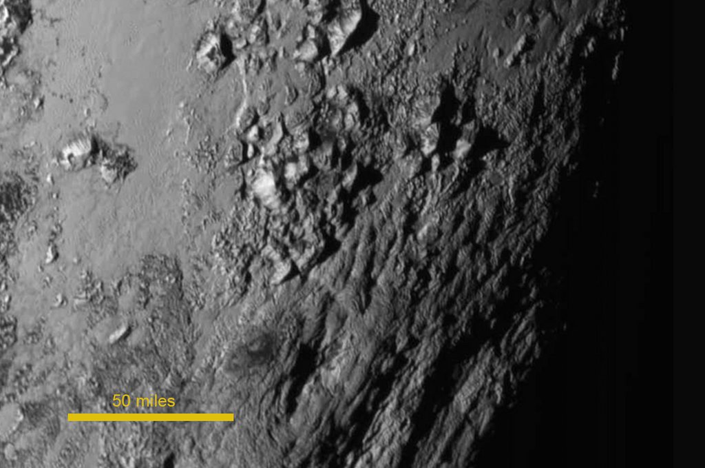 epa04848277 A handout photo released by NASA on 15 July 2015 shows a new close-up image of a region near Pluto's equator which reveals a range of youthful mountains rising as high as 11,000 feet (3,500 meters) above the surface of the icy body. The image was taken about 1.5 hours before New Horizon's closest approach to Pluto, when the craft was 478,000 miles (770,000 kilometers) from the surface of the planet.  EPA/NASA / HANDOUT Image Credit: NASA-JHUAPL-SwRI HANDOUT EDITORIAL USE ONLY