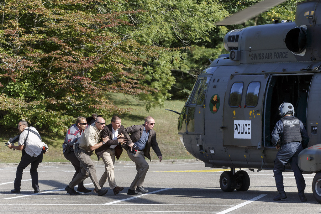 A faked head of state is evacuated by Swiss police and U.N. security, during an U.N. security and Swiss police, at the European headquarters of the United Nations in Geneva, Switzerland, Tuesday, August 25, 2015. A Puma helicopter of the Swiss army landed in the UN park to participate in the extraction of a false head of state victim of an attempted assault in a conference room, during a joint exercise of the U.N. Security Service and Police of Switzerland. (KEYSTONE/Salvatore Di Nolfi)