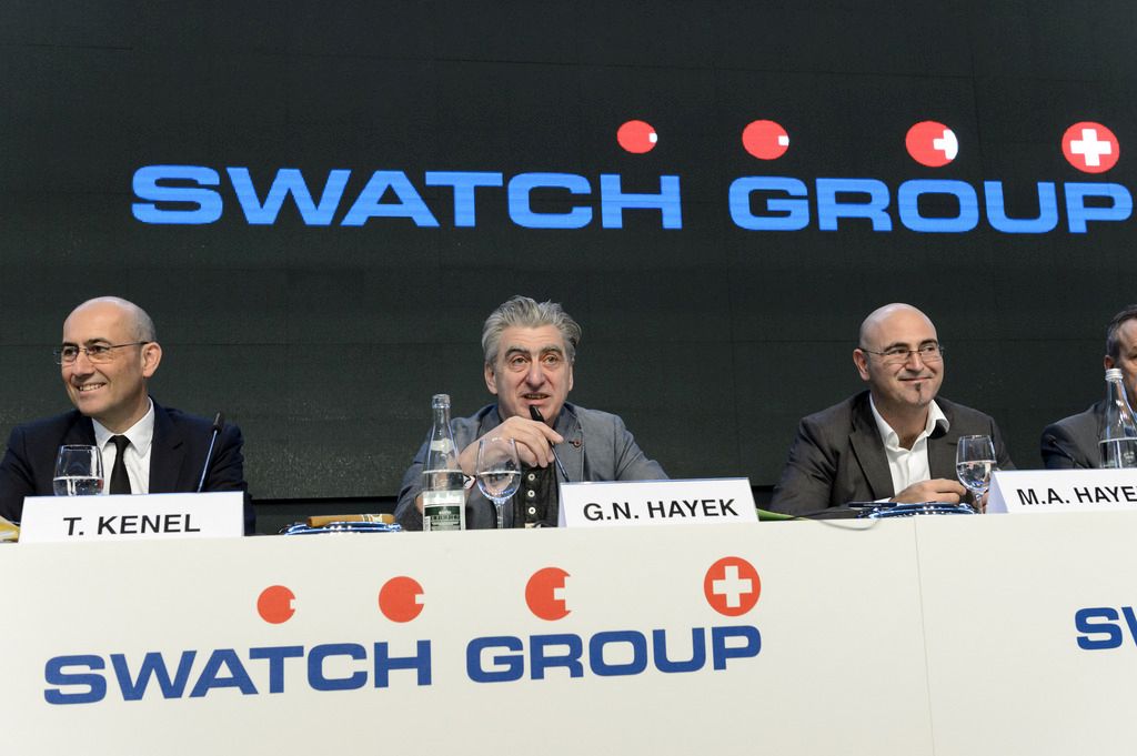 From left, CEO of Swatch Group Thierry Kenel, CEO of Swatch Group Nick Hayek, and Marc A. Hayek, manager of the watch manufacturers Breguet and Blancpain, speak during a press conference of the year 2014 final results of Swiss watch company Swatch Group, in Corgemont, Switzerland, Thursday, March 12,  2015. (KEYSTONE/Laurent Gillieron)