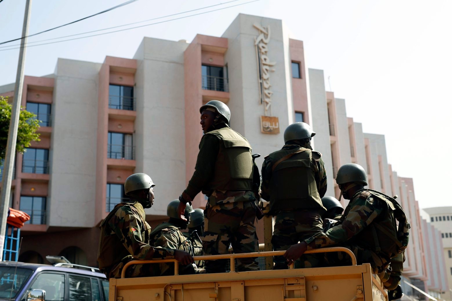Soldiers from the presidential patrol outside the Radisson Blu hotel in Bamako, Mali, Saturday, Nov. 21, 2015, in anticipation of the President's visit. Malian security forces were hunting "more than three" suspects after a brazen assault on a luxury hotel in the capital that killed 20 people plus two assailants, an army commander said Saturday. (AP Photo/Jerome Delay) APTOPIX Mali Hotel Attack