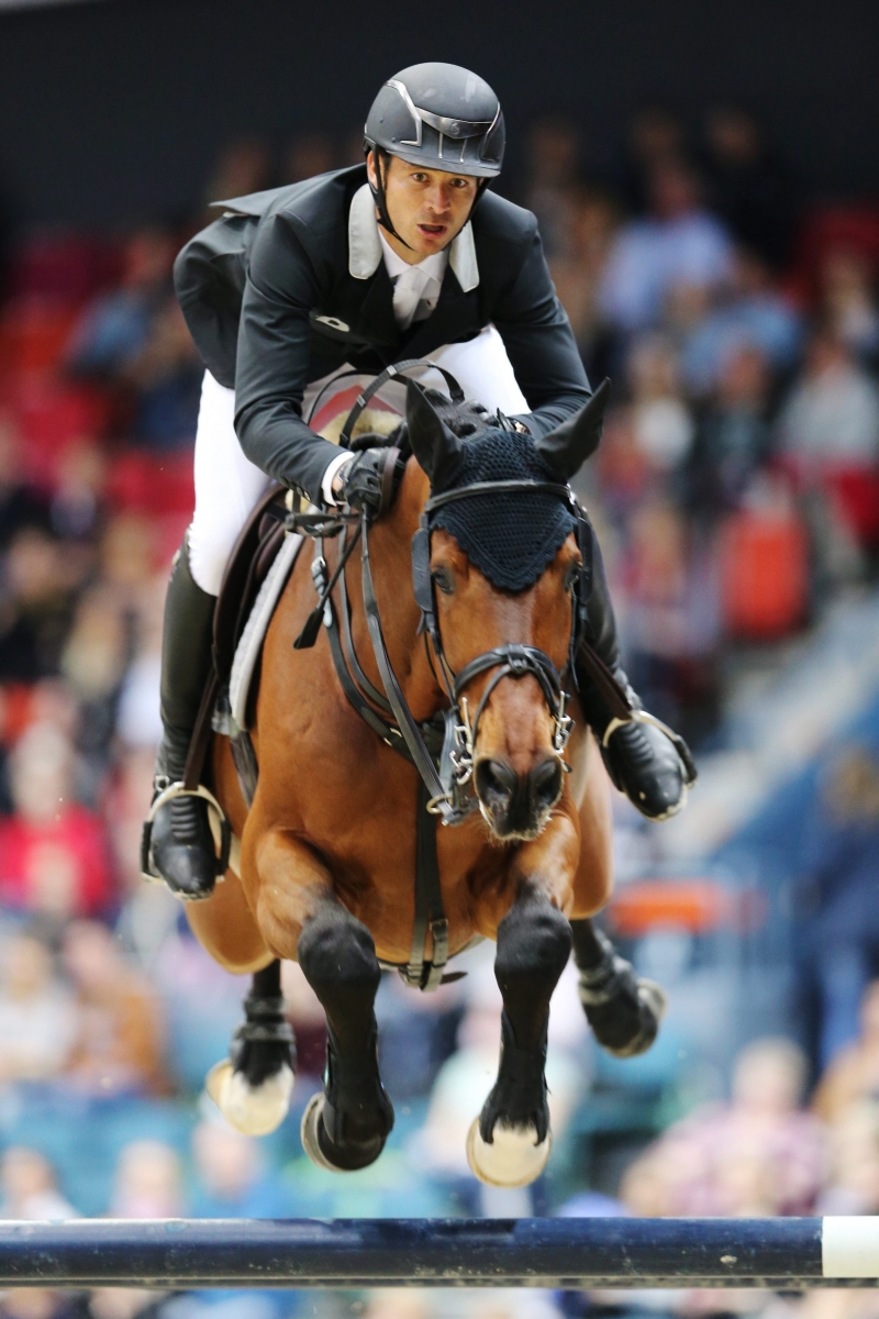 epa05230989 Steve Guerdat  of Switzerland rides his horse Corbinian during the Longines FEI World Cup Jumping Final I event during the Gothenburg Horse Show at Scandinavium Arena in Gothenburg, Sweden, 25 March 2016.  EPA/BJORN LARSSON ROSVALL SWEDEN OUT SWEDEN EQUESTRIAN
