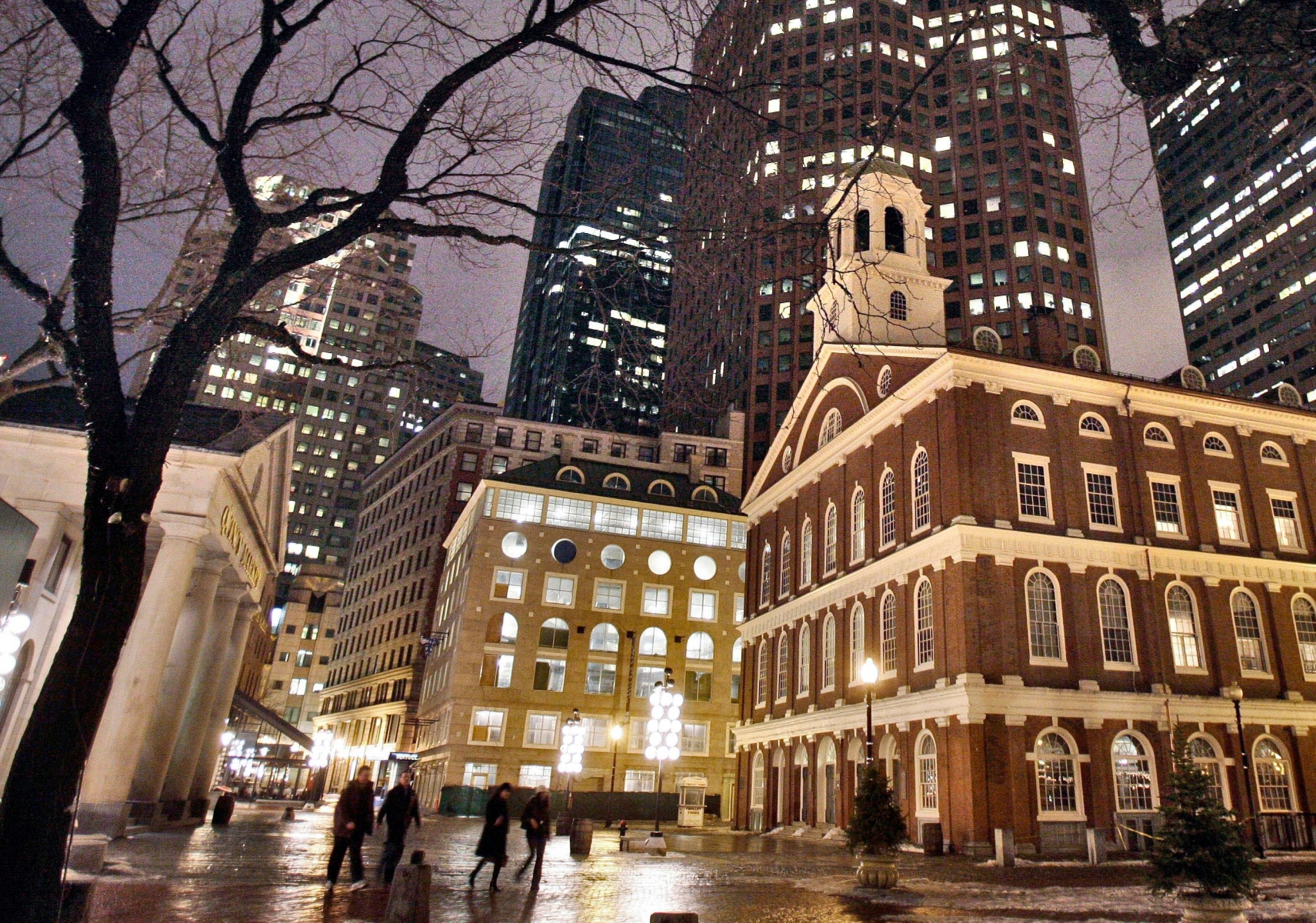 FILE - In this Feb. 22, 2007 file photo, Faneuil Hall, right, one of the sites on Boston's Freedom Trail, sits among buildings on an evening in downtown in Boston. With scientists forecasting sea levels to rise by anywhere from several inches to several feet by 2100, historic structures and coastal heritage sites around the world are under threat. A multidisciplinary conference is scheduled to convene in Newport, R.I., this week to discuss preserving those structures and neighborhoods that could be threatened by rising seas. (AP Photo/Michael Dwyer, File) DROWNING HISTORY