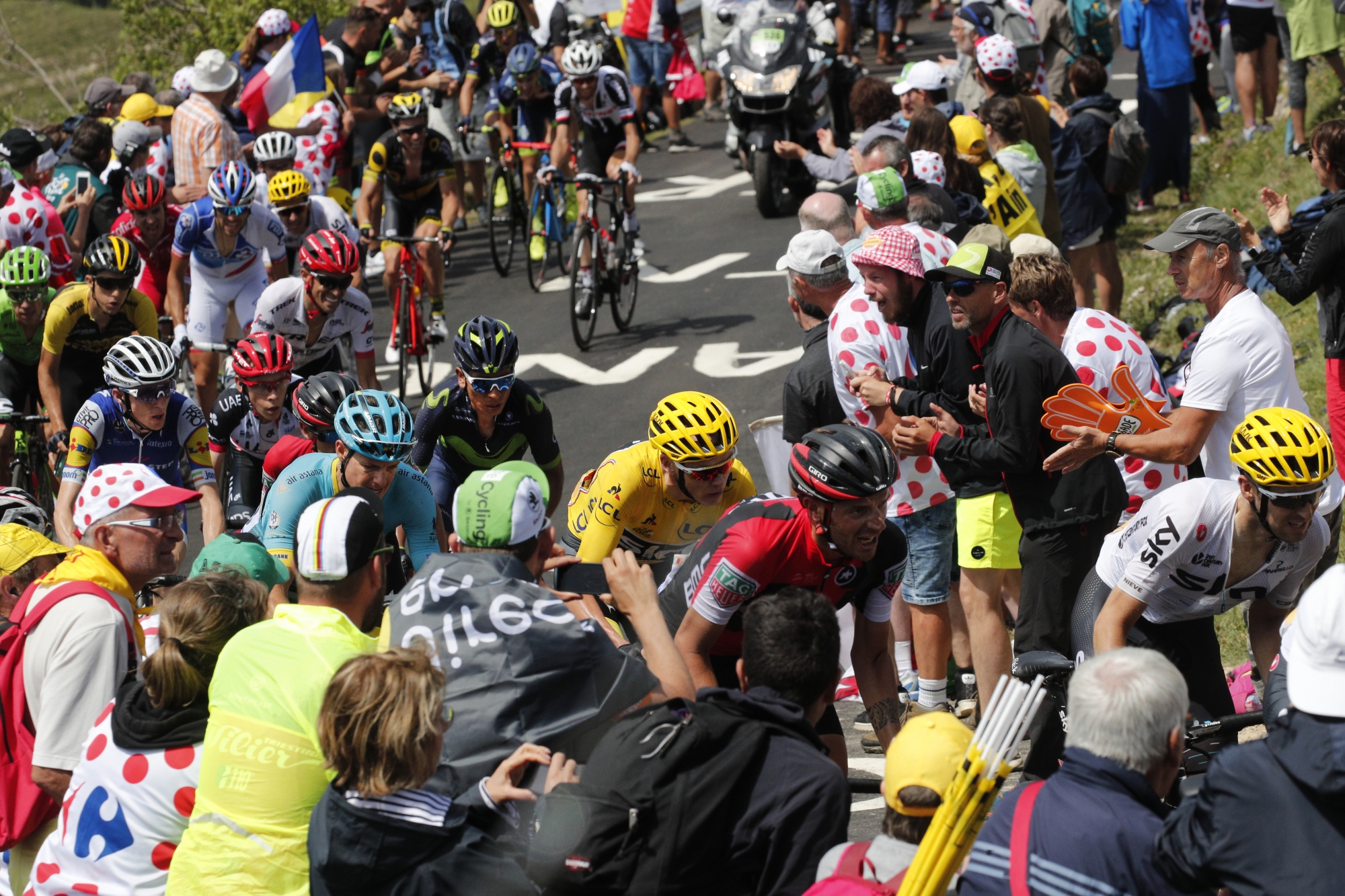 Britain's Chris Froome, wearing the overall leader's yellow jersey, is followed by Denmark's Jakob Fuglsang, Australia's Richie Porte, Colombia's Nairo Quintana, and Ireland's Daniel Martin, far left in blue and yellow, as he climbs towards Grand Colombier pass during the ninth stage of the Tour de France cycling race over 181.5 kilometers (112.8 miles) with start in Nantua and finish in Chambery, France, Sunday, July 9, 2017. (AP Photo/Christophe Ena) France Cycling Tour de France