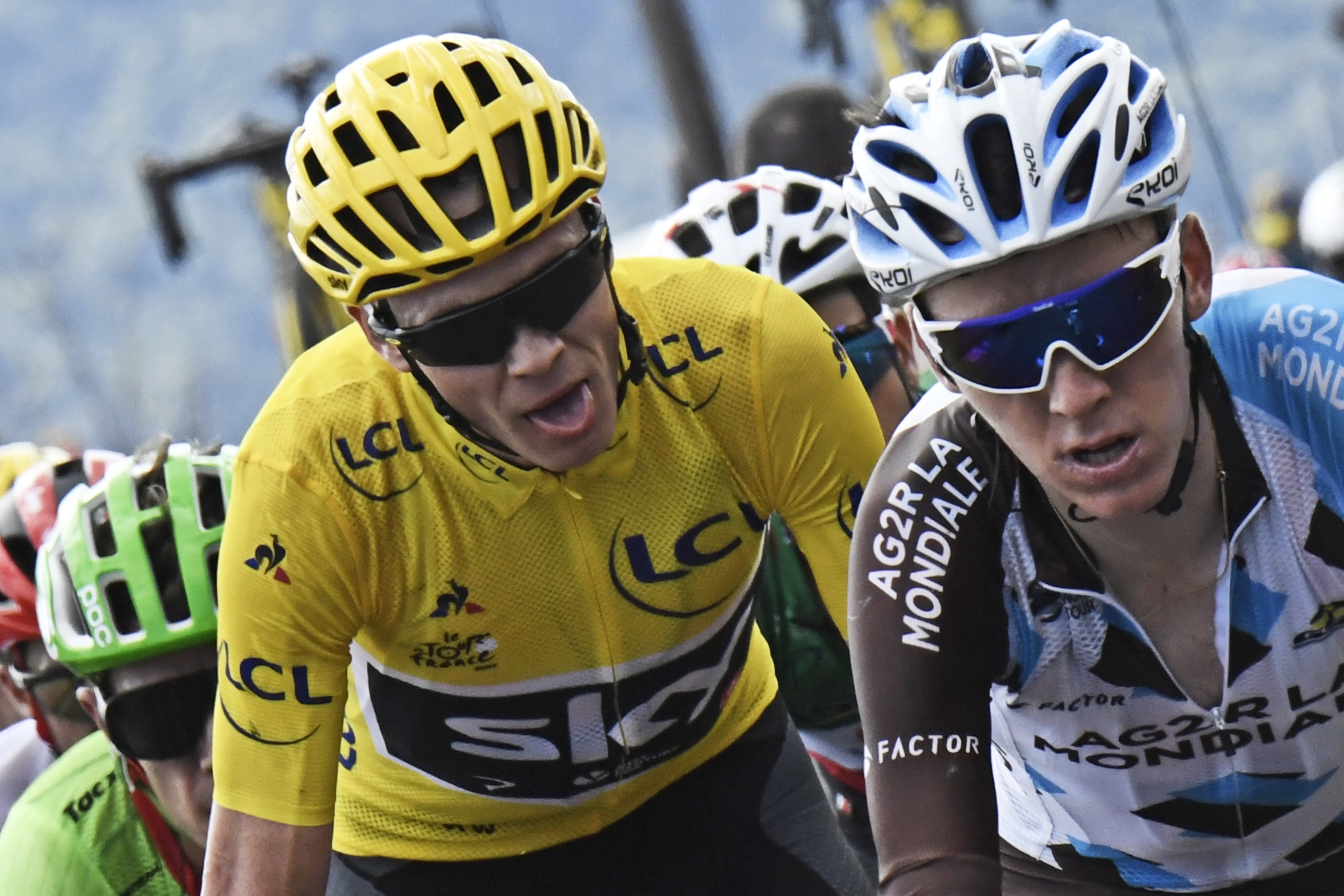 Britain's Chris Froome, wearing the overall leader's yellow jersey, grimaces, as he climbs with France's Romain Bardet, right, and Colombia's Rigoberto Uran, left, during the fifteenth stage of the Tour de France cycling race over 189.5 kilometers (117.8 miles) with start in Laissac-Severac l'Eglise and finish in Le Puy-en-Velay, France, Sunday, July 16, 2017. (Jeff Pachoud, Pool photo via AP) France Cycling Tour de France