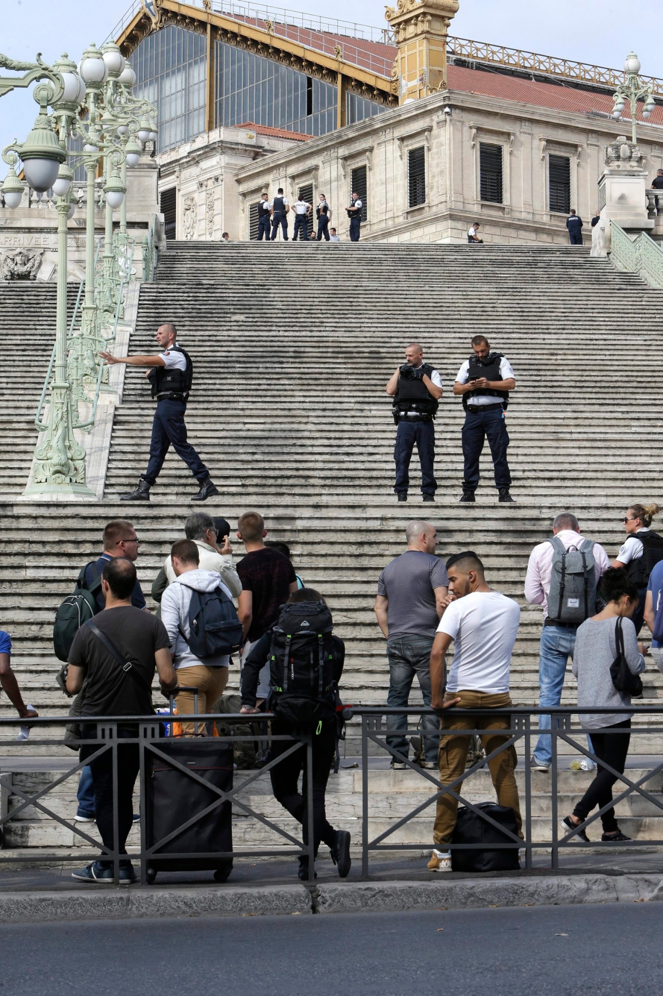 French police officers block access on the stairs leading to Marseille 's main train station, Sunday, Oct. 1, 2017 in Marseille, southern France. French police warn people to avoid Marseille's main train station amid reports of knife attack, assailant shot dead. (AP Photo/Claude Paris) France Knife Attack