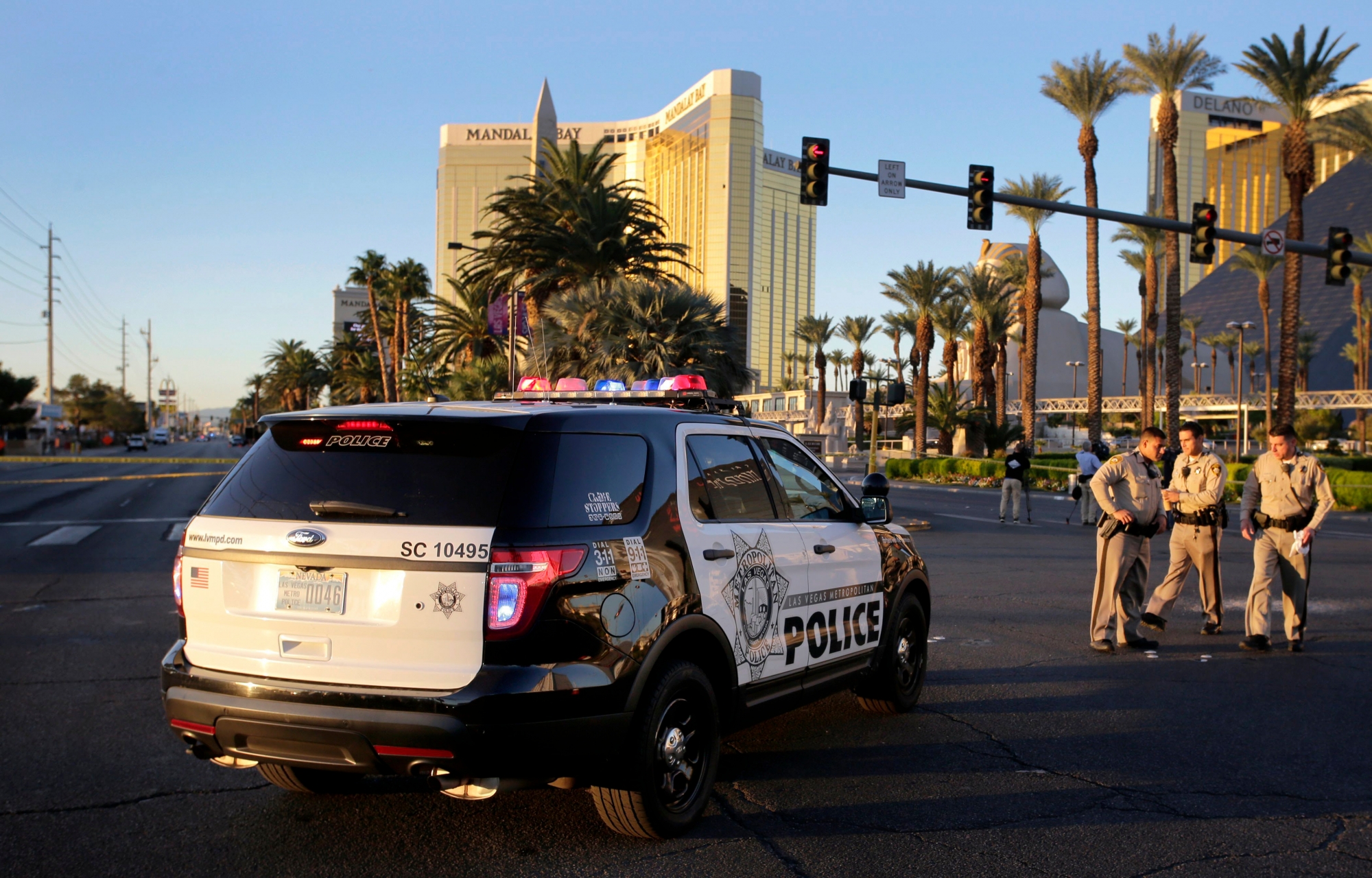 epa06242252 Police officers block Las Vegas Boulevard in front of the Mandalay Bay Hotel and Casino where a gunman fired from during the Route 91 Harvest festival on Las Vegas Boulevard in Las Vegas, Nevada, USA, 03 October 2017. Police reports indicate that a gunman, identified as Stephen Paddock, 64, firing from an upper floor in the Mandalay Bay hotel killed more than 50 people and injured more than 500 before he reportedly killed himself as police made their way to his hotel room.  EPA/PAUL BUCK USA LAS VEGAS SHOOTING