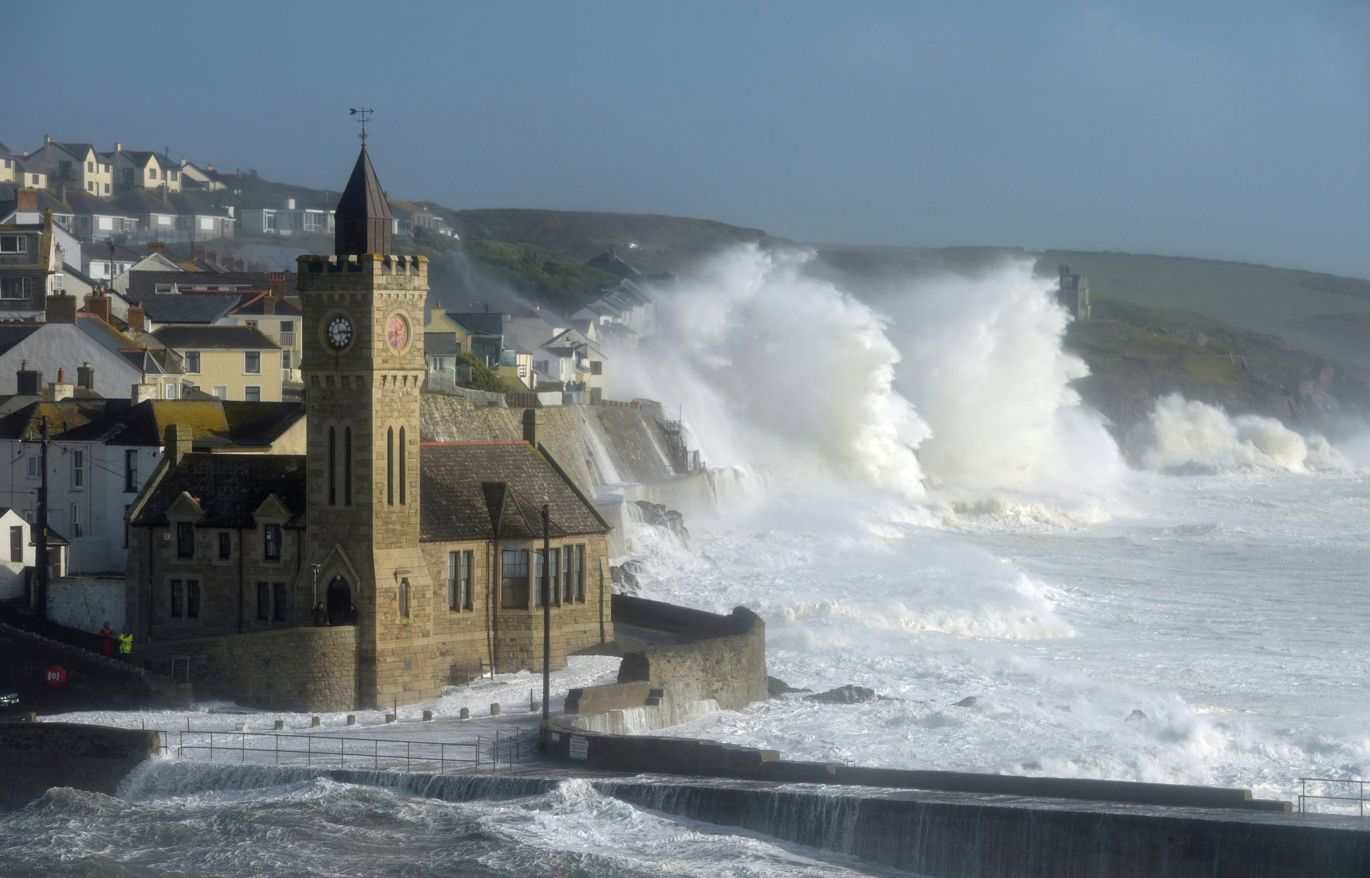 Waves break around the church in the harbour at Porthleven, Cornwall southwestern England, as the remnants of  Hurricane Ophelia begins to hit parts of Britain and Ireland. Ireland's meteorological service is predicting wind gusts of 120 kph to 150 kph (75 mph to 93 mph), sparking fears of travel chaos. Some flights have been cancelled, and aviation officials are warning travelers to check the latest information before going to the airport Monday.  (Ben Birchall/PA via AP) Britain Tropical Weather