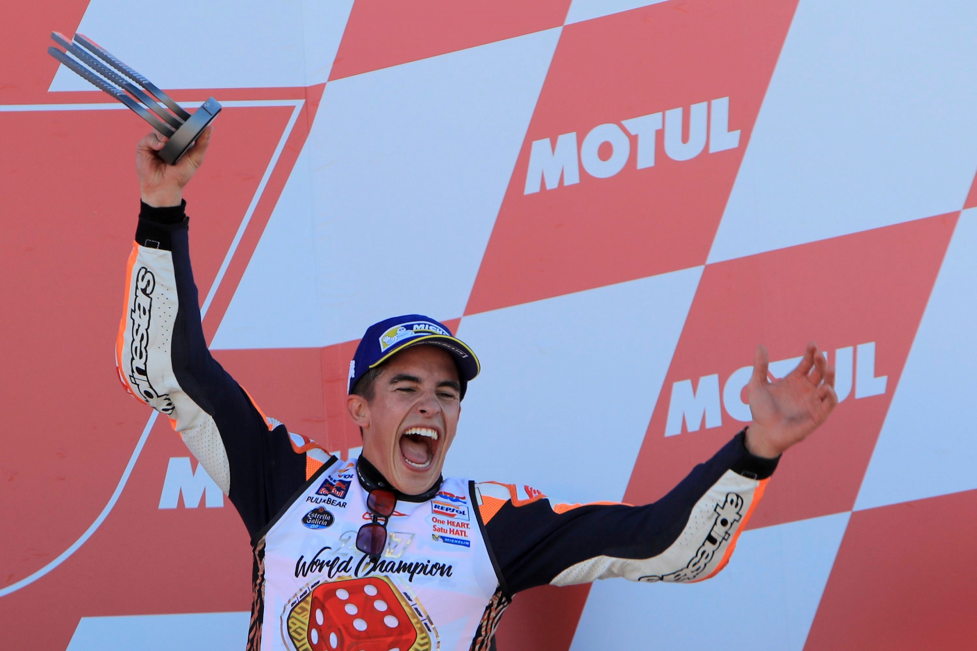 Moto GP World Champion winner Marc Marquez of Spain celebrates on the podium after finishing third at the Valencia Motorcycle Grand Prix, the last race of the season, at the Ricardo Tormo circuit in Cheste near Valencia, Spain, Sunday Nov. 12, 2017. Marquez won his fourth MotoGP world title on Sunday after challenger Andrea Dovizioso crashed during the season-concluding Valencia Grand Prix. (AP Photo/Alberto Saiz) Spain GP Motorcycle Racing