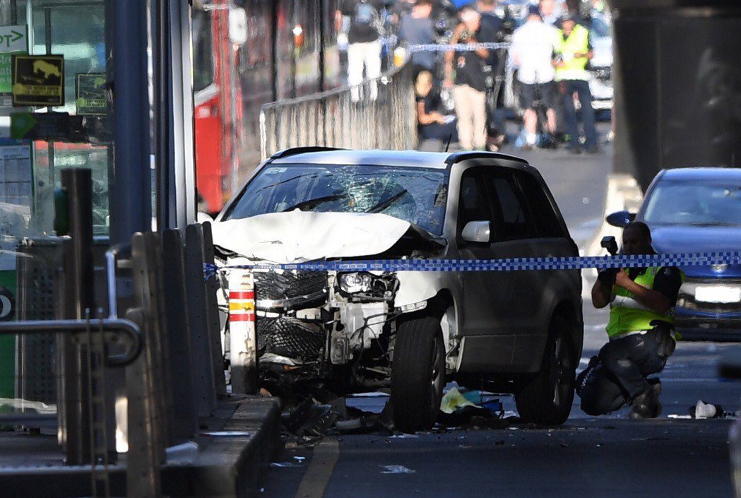 epaselect epa06401079 A damaged vehicle at the scene of an incident on Flinders Street, in Melbourne, Australia, 21 December 2017. Twelve people are being treated by paramedics after a car, understood to be a white Suzuki SUV, ploughed into pedestrians in central Melbourne.  EPA/JOE CASTRO AUSTRALIA AND NEW ZEALAND OUT epaselect AUSTRALIA VEHICLE INCIDENT MELBOURNE