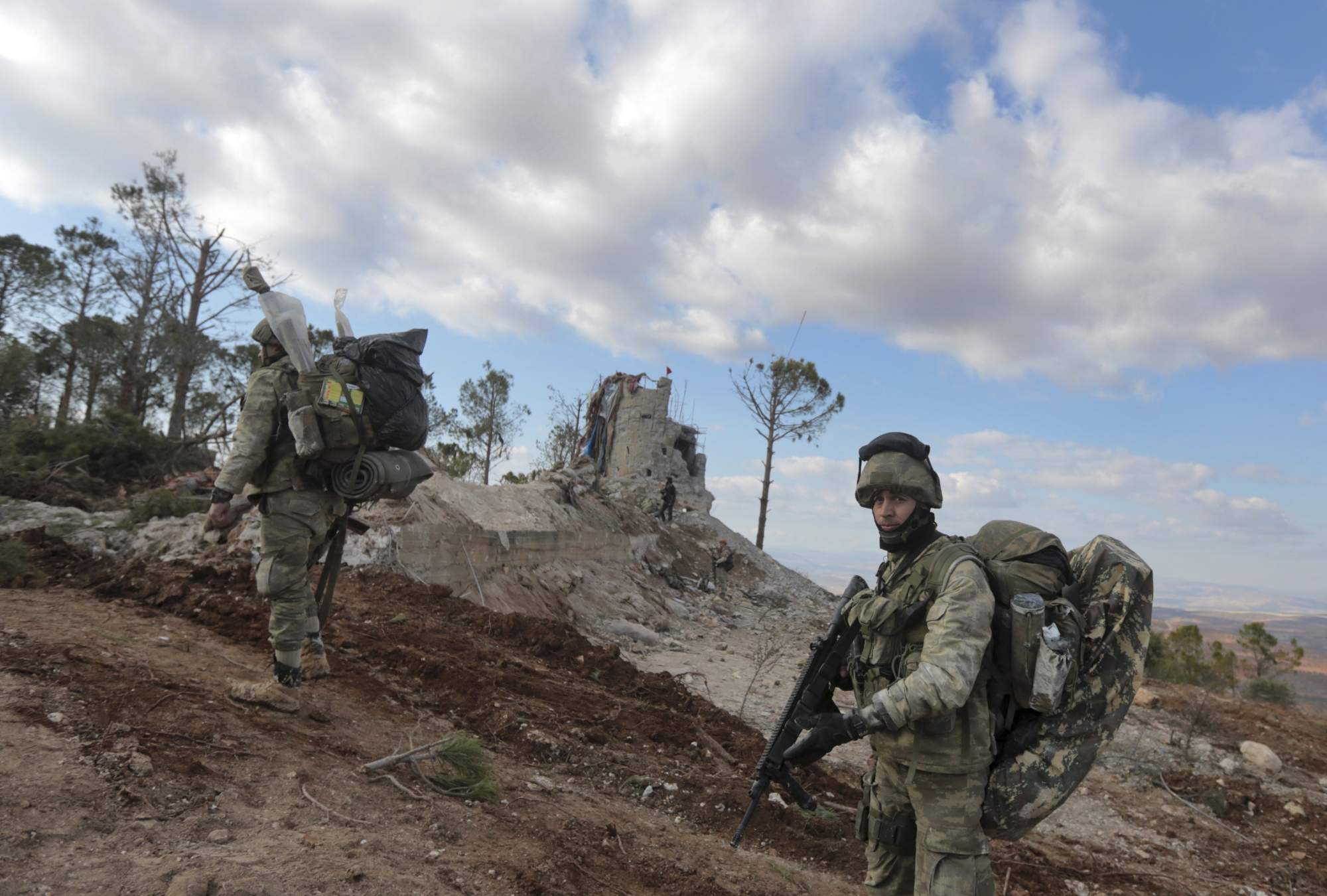 Turkish troops secure the Bursayah hill, which separates the Kurdish-held enclave of Afrin from the Turkey-controlled town of Azaz, Syria, Sunday, Jan. 28, 2018. Turkish troops and allied Syrian fighters captured the strategic hill in northwestern Syria after intense fighting on Sunday as their offensive to root out Kurdish fighters enters its second week, Turkey's military and Syrian war monitor reported. (AP Photo) Syria