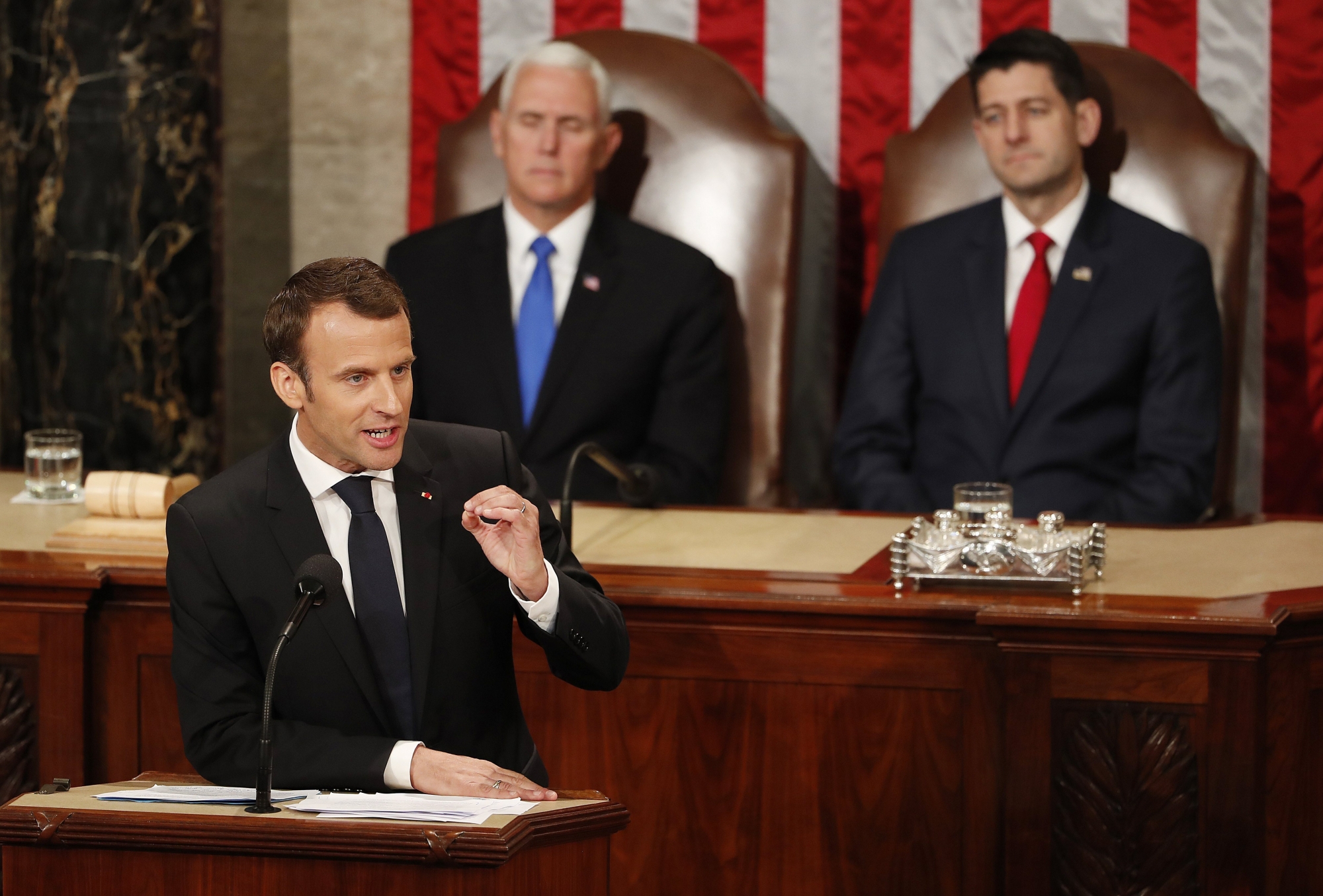 epa06692234 French President Emmanuel Macron during his address to a joint meeting of Congress in the House chamber on Capitol Hill in Washington, DC, USA, 25 April 2018. President Macron is on a three-day visit to Washington DC, where he met with US President Donald J. Trump before addressing Congress.  At rear are US Vice president Mike Pence (L) and Speaker of the House Paul Ryan (R).  EPA/ERIK S. LESSER USA FRANCE MACRON CONGRESS