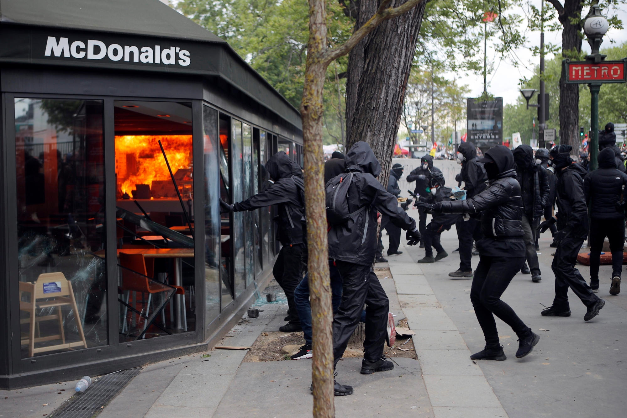 A McDonald's restaurant is hit with petrol bombs thrown by activists during the traditional May Day rally in the center of Paris, France, Tuesday, May 1, 2018. Each year, people around the world take to the streets to mark International Workers' Day, or May Day. (AP Photo/Francois Mori) France May Day