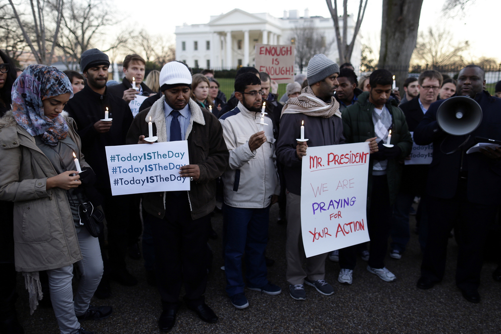 Supporters of gun control gather on Pennsylvania Avenue in front of the White House in Washington, Friday, Dec. 14, 2012, during a vigil for the victims of the shooting at Sandy Hook Elementary School in Newtown, Ct., and to call on President Obama to pass strong gun control laws. (AP Photo/Charles Dharapak)