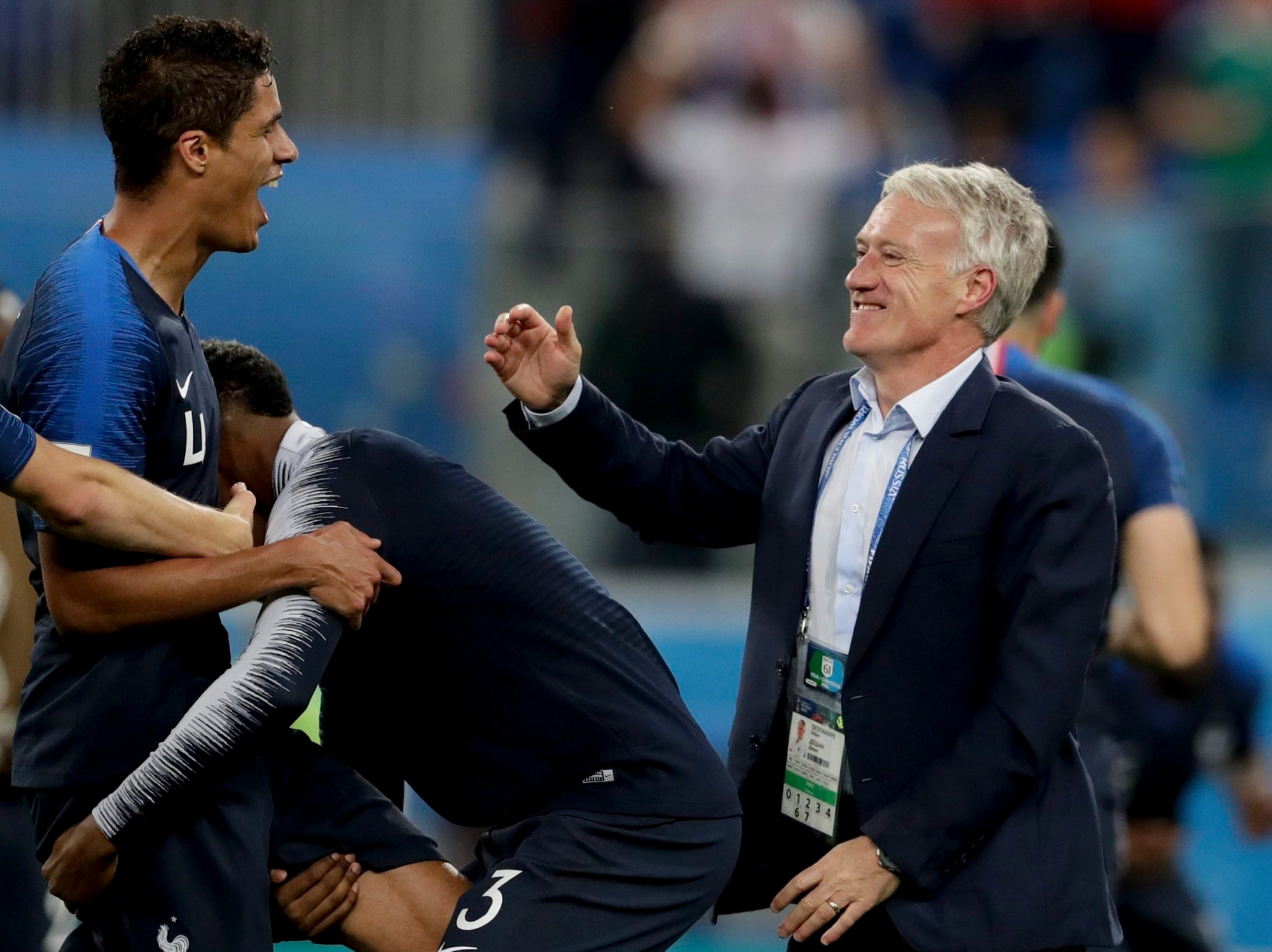 France head coach Didier Deschamps, right, and Raphael Varane celebrate at the end of the semifinal match between France and Belgium at the 2018 soccer World Cup in the St. Petersburg Stadium, in St. Petersburg, Russia, Tuesday, July 10, 2018. France won 1-0. (AP Photo/Petr David Josek) Russia Soccer WCup France Belgium
